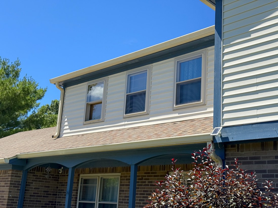 Close-up of repainted siding and window trim detail