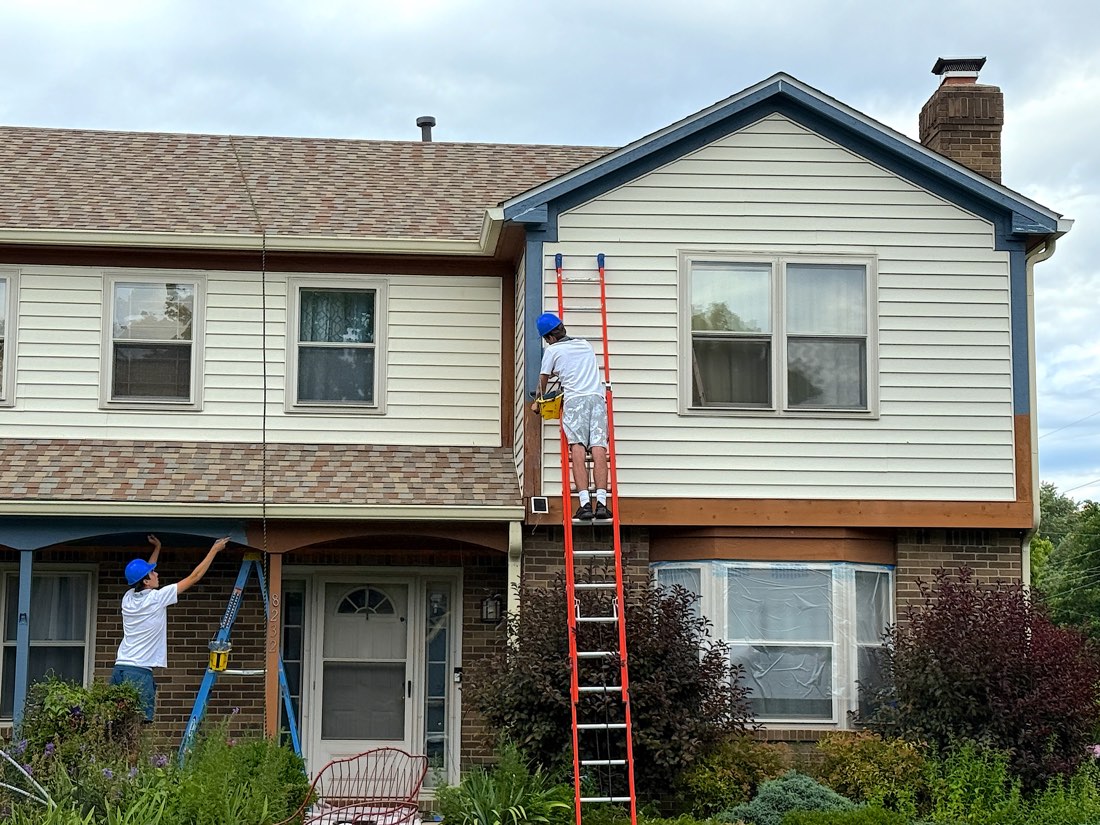 Hendricks House Painting crew painting trim on a two-story home
