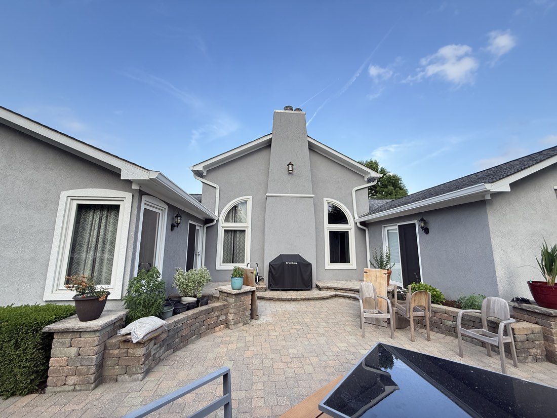 Stucco courtyard repainted in light gray with white accents