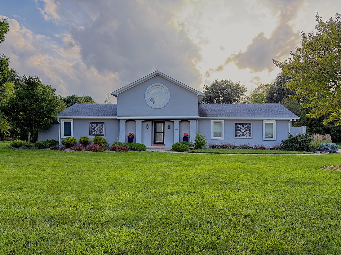 Repainted gray stucco home with bright white trim